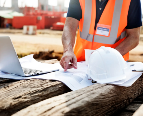 An RTSC consultant in a hard hat inspecting a Honolulu construction site, representing expert construction safety consulting in Hawaii.